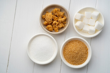 Various types of sugar,palm sugar and white brown and cube sugar on white bowl