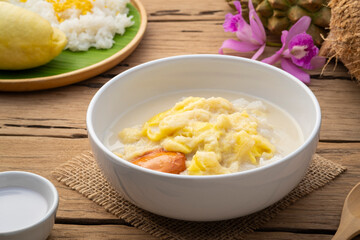 Thai sweet food,Cooked sticky rice in sweet coconut milk with Durian fruit in white bowl,popular dessert in Thailand