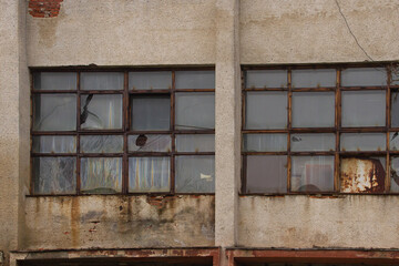 an old, abandoned building with rust and broken windows.