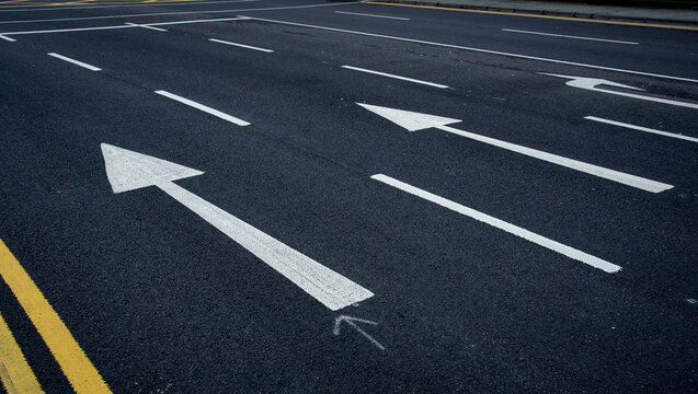 Arrow direction signs on asphalt road. Mission future ahead