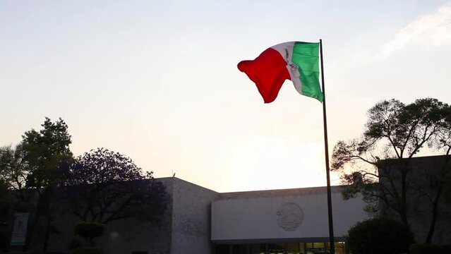 Mexico national flag waving in beautiful sky.