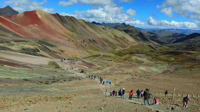 Tourists arriving in the top of Seven Colors Mountain, or Vinicunca Mountain, one of the most famous peaks in Peru, a must see destination in the country