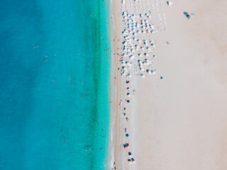 Aerial photograph capturing sunbathers enjoying the sandy Belcekiz Beach in &Ouml;l&uuml;deniz, Muğla, Turkey, taken from a drone's bird's-eye view.