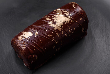 Delicious sweet cheese with syrup covered with chocolate and nuts