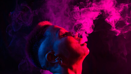 Portrait asian woman with shaved temples smokes vape in neon light.