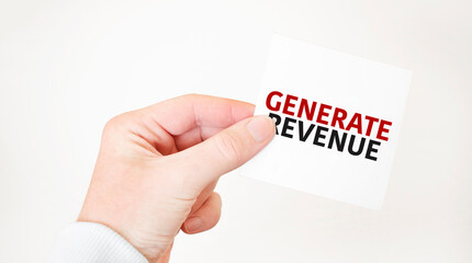Businessman holding a white card with text GENERATE REVENUE, business concept