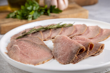 Sliced roast beef on plate.