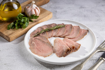 Sliced roast beef on plate.