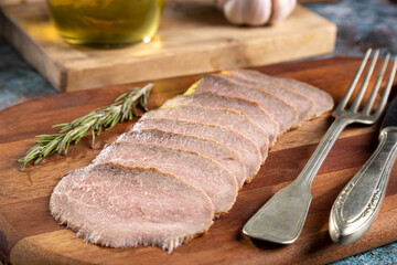 Sliced roast beef on cutting board.