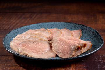 Sliced roast beef on plate.
