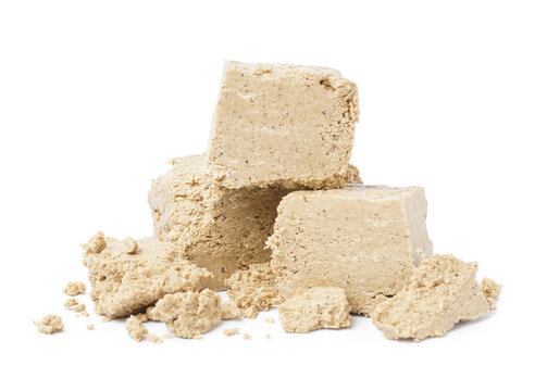 Pieces of sweet halva on white background