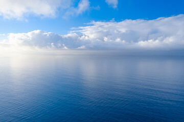 Fototapeta premium Sea and water, beautiful calm landscape of clouds reflecting in the water, view from mirador del malcon on Gran Canaria.