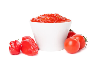 Bowl of delicious salsa sauce, tomatoes and peppers isolated on white background