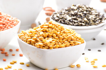 Close Up of uncooked chana dal in bowl on white background