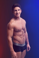 Fototapeta premium Young muscled man posing is studio.