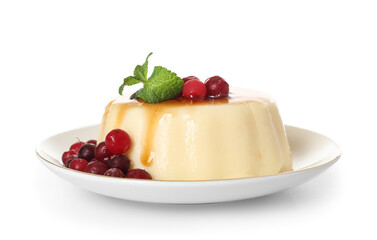 Plate with delicious pudding, mint and cranberries covered by caramel syrup isolated on white background