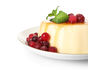 Plate with delicious pudding, mint and cranberries covered by caramel syrup isolated on white background