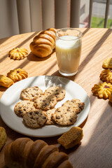 table served and ready with homemade cookies, bread and glass of milk, food and drink ready to eat, wallpaper with pastry desserts