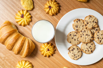 pastry shop wallpaper, table with chocolate cookies, bread and a glass of fresh milk, delicious food and drink, texture details