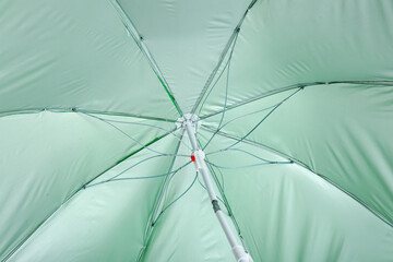 Green beach umbrella as background