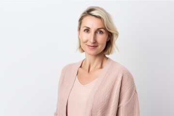 Obraz premium Portrait of a beautiful blonde woman in a pink sweater on a white background