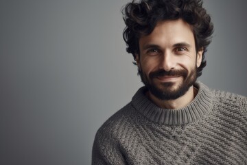 Portrait of handsome young man with beard and mustache in sweater.