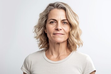 Fototapeta premium Medium shot portrait photography of a grinning woman in her 40s wearing a casual t-shirt against a white background. Generative AI