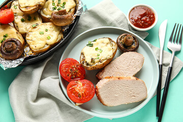 Plate with tasty baked meat, potatoes and vegetables and sauce on color background, closeup