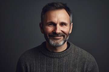 Fototapeta premium Portrait of a handsome middle-aged man in a gray sweater.