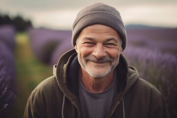 Portrait of smiling senior man in lavender field at sunset.