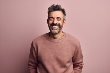 Fototapeta premium Portrait of a smiling middle-aged man on a pink background