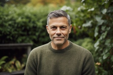 Portrait of a handsome middle-aged man in a green sweater