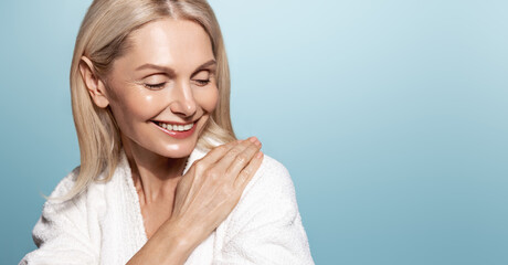Wellbeing and beautiful aging. Smiling senior woman with healthy, hydrated skin with natural glow,...