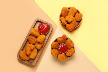 Tasty nuggets with ketchup on color background