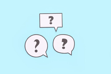 Speech bubbles with question marks on blue background