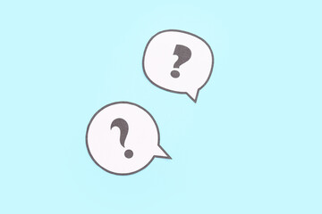 Speech bubbles with question marks on blue background