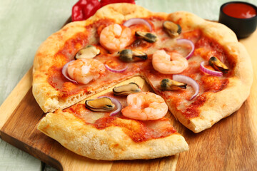 Board of tasty seafood pizza on light wooden background