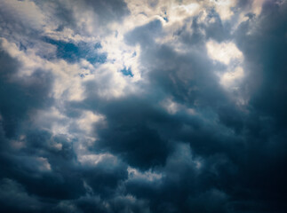 Naklejka na ściany i meble sunlight peeking through a dramatic cloudy sky