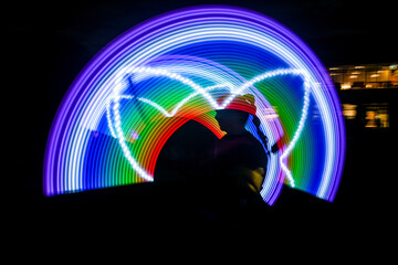 silueta de una mujer haciendo malabares con luces led