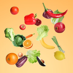 Many fresh vegetables and fruits falling on light orange background