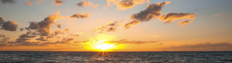 Naklejka na ściany i meble Beautiful sky with sun over sea at sunset, banner design