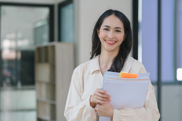 Young Indian businesswoman working with a pile of documents at her office workplace, focusing on business finance and accounting concepts.