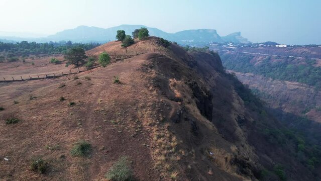 Aerial footage of a scene at the edge of a mountain at Kune village near Khandala India.