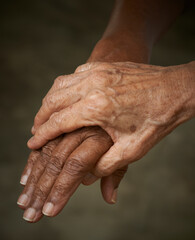 Helping hands. Caregiver, carer hand holding elder hand. Care for the eldery concept. Two womans hands.