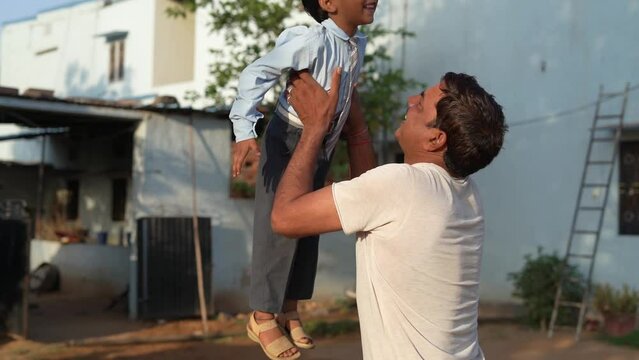 Father's day. The child wants to fly above the ground. A parent with a child plays at dawn. Family and childhood concept.