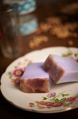 nyonya kuih (kuih bengka purle) on vintage glass background