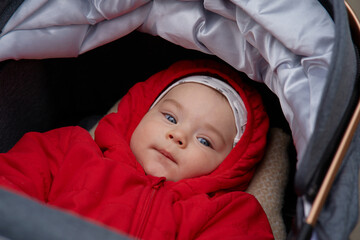 Closeup portrait of beautiful baby boy in stroller