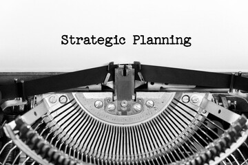 Strategic Planning phrase closeup being typing and centered on a sheet of paper on old vintage typewriter mechanical