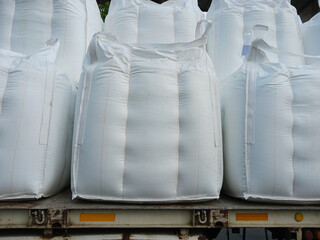 Chemical fertilizer The product stock is packed in sacks, stacked in the warehouse, waiting for delivery. - obrazy, fototapety, plakaty