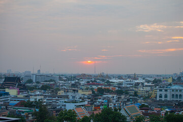 .The colorful sky over Bangkok city center in the evening..amazing red sky at sunset..Temples and buildings in Bangkok background..